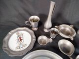 a lot of silver dishes and cups on the table
