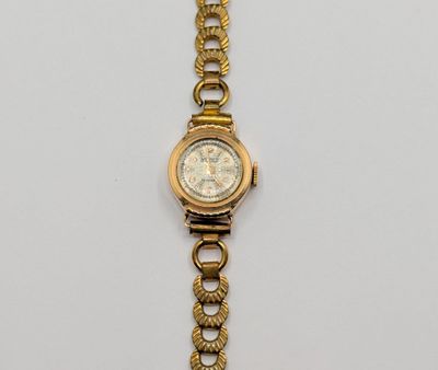 an image of a gold wrist watch with a chain around it