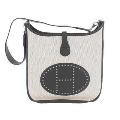black and white bag with a smiley face on the front