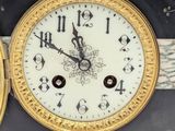 a black and gold clock with roman numerals on it