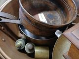 a lot of old pots and pans sitting on a table