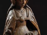 an old wooden statue of a woman holding a baby