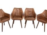 three brown leather chairs sitting next to each other on a white surface