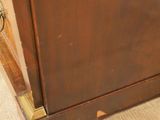 a wooden cabinet with a metal handle on top of it