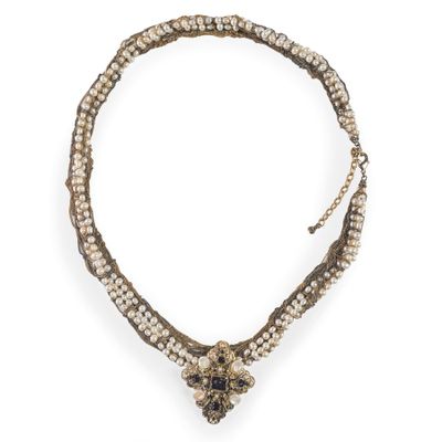 a close up of a necklace on a white background