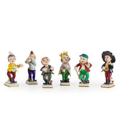 five figurines of people dressed in different outfits and hats