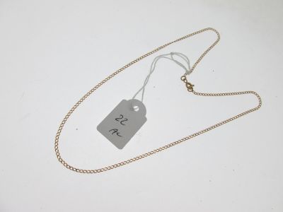 a close up of a tag on a chain on a white surface