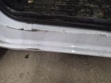 a white car with a dirty door handle and a dirty door handle