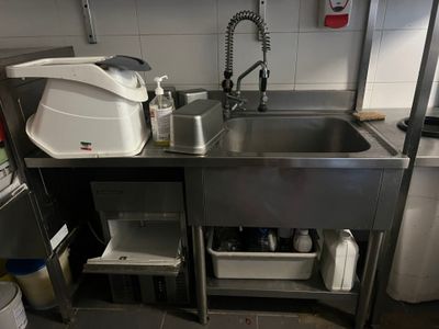a kitchen with a stainless steel sink and a dishwasher