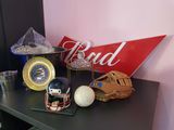 a baseball glove, ball, and clock on a table