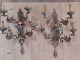 two sconces on the wall that have blue glass on them