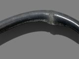 a close up of a steering wheel on a gray background