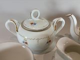 a white tea pot with a gold rim and a white tea pot with a gold rim and a white tea pot with a gold rim