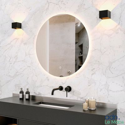 une salle de bains équipée d'un lavabo, d'un miroir et d'un tabouret