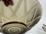 a clear glass bowl with a decorative design on it