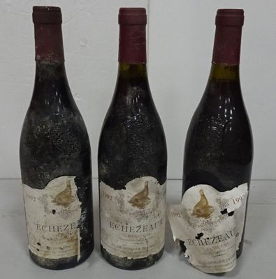 three bottles of wine sitting next to each other on a table
