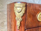 a wooden chest of drawers with brass knobs on it