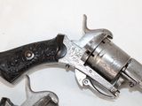 two revolvers that are sitting on a table