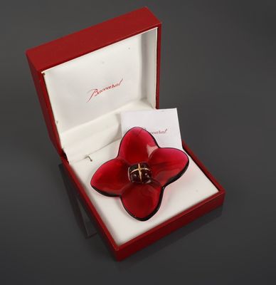 a red flower shaped ring in a red box