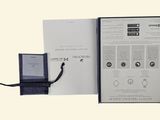 an open book with a picture of a watch inside of it