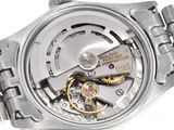 a close up of a watch with a metal band