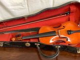 a violin and a violin case on a table