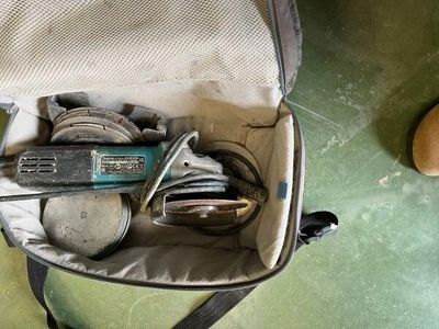 a bag full of tools sitting on the floor