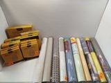 many rolls of fabric in a box on the floor