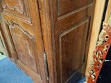 a large wooden door with a mirror on the floor