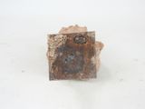 a small piece of rock that is sitting on a white surface