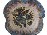 a blue and brown plate with a floral design on it