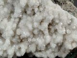 a close up of a piece of rock with white crystals on it