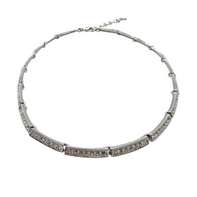 a close up of a necklace on a white background