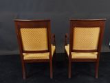 two wooden chairs with yellow upholstered upholstered seats