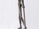 statue of a man holding a pair of skis on top of a wooden base