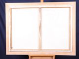 an easel with a white canvas on a black background