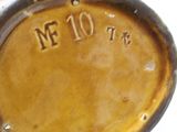 a close up of a brown vase with the number 10 on it