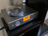 a flat screen tv sitting on top of a black stand