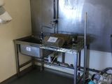 a kitchen with a sink and a metal counter