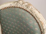 a white chair with a green upholstered upholstered upholstered upholstered upholstered upholstered upholstered upholstered