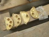 four pieces of brass that are on a piece of wood