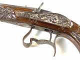a close up of a gun on a white surface with a white background