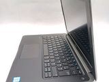 a laptop that is open on a white surface