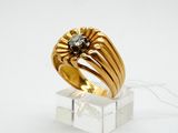 a close up of a gold ring with a diamond on it