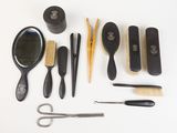 many different types of hair brushes and combs on the table