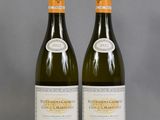 two bottles of wine sitting next to each other on a table