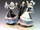 two figurines of a man and a woman dancing