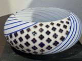 a white bowl with blue and black designs on it
