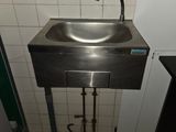 a sink in a public restroom with a faucet on the side