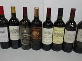 several bottles of wine are lined up on a table